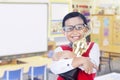 Boy holding trophy in classroom Royalty Free Stock Photo