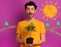 Happy boy holds a small tree ready to be planted over a light color. concept of forestation, ecology and conservation Royalty Free Stock Photo