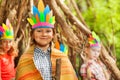 Happy boy in Injun`s costume playing with friends Royalty Free Stock Photo