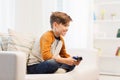 Happy boy with joystick playing video game at home Royalty Free Stock Photo