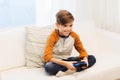 Happy boy with joystick playing video game at home Royalty Free Stock Photo