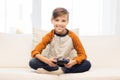 Happy boy with joystick playing video game at home Royalty Free Stock Photo