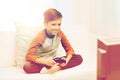 Happy boy with joystick playing video game at home Royalty Free Stock Photo