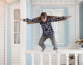 Happy boy jump with cardboard boxes of wings Royalty Free Stock Photo