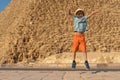 Happy boy jumping in front of the Cheops pyramid on the Giza plateau Royalty Free Stock Photo