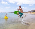 Happy boy is jumping into the ocean in Lanzarote Royalty Free Stock Photo