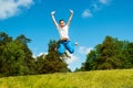 Happy boy jumping outdoors