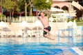 Happy boy jumping in swimming pool Royalty Free Stock Photo