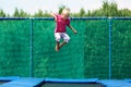 Happy boy jumping on trampoline Royalty Free Stock Photo