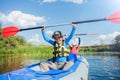 Happy boy kayaking on the river on a sunny day during summer vacation Royalty Free Stock Photo