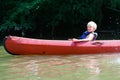 Happy boy kayaking on the river Royalty Free Stock Photo