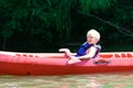 Happy boy kayaking on the river Royalty Free Stock Photo