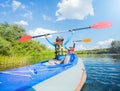 Happy boy kayaking on the river on a sunny day during summer vacation Royalty Free Stock Photo