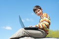 Happy boy with a laptop Royalty Free Stock Photo