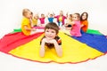 Happy boy laying on parachute during social games Royalty Free Stock Photo