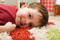 Happy boy laying on a rug Royalty Free Stock Photo