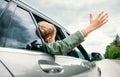 Happy boy look out from auto window Royalty Free Stock Photo