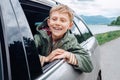 Happy boy look out from auto window Royalty Free Stock Photo