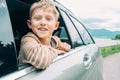 Happy boy look out from window car Royalty Free Stock Photo