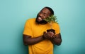 Happy boy loves a small tree ready to be planted. Concept of forestation Royalty Free Stock Photo