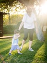 Happy boy making funny faces and expressions while walking with his grandmother Royalty Free Stock Photo