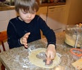 Happy boy making heart cookies