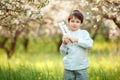 Happy boy with marshmallow on sticks in blooming garden Royalty Free Stock Photo
