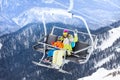 Happy boy with mother sit on skilift ropeway chair Royalty Free Stock Photo