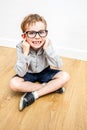 Happy boy with nerd eyeglasses covering ears for self-respect Royalty Free Stock Photo