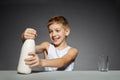 Happy boy opening bottle of milk
