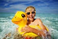 Happy boy in orange sunglasses with yellow inflatable duck Royalty Free Stock Photo