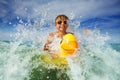 Portrait of boy in orange sunglasses with yellow inflatable duck Royalty Free Stock Photo