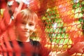 Happy boy passing cable tunnel. Outdoors playground, leisure for kids. Summer vacations Royalty Free Stock Photo