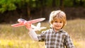 Happy boy play airplane. Little boy with plane. Little kid dreams of being a pilot. Child playing with toy airplane