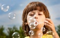 Happy Boy play in bubbles in field sunny summer day Royalty Free Stock Photo