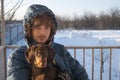 Happy boy playing with dog in winter day, dog and child on snow Royalty Free Stock Photo