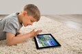 Happy Boy Playing Game On Digital Tablet Royalty Free Stock Photo