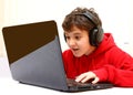 Happy boy playing a game on laptop - computer Royalty Free Stock Photo