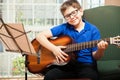 Happy boy playing the guitar Royalty Free Stock Photo