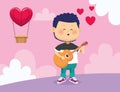 Happy boy playing guitar and singing over hot air balloon with heart shape Royalty Free Stock Photo