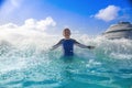 Happy Boy playing in the ocean waves while on a Cruise vacation Royalty Free Stock Photo