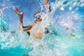 Happy boy playing and splashing in swimming pool Royalty Free Stock Photo