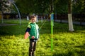 Happy boy is playing tetherball swing ball game in summer camping. Happy leisure healthy active time outdoors concept