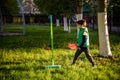 Happy boy is playing tetherball swing ball game in summer camping. Happy leisure healthy active time outdoors concept