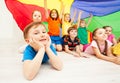 Happy boy playing under parachute with friends Royalty Free Stock Photo