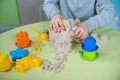 Happy boy plays kinetic sand at home Royalty Free Stock Photo