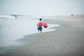 Happy boy plays with red balloons on the beach having great holidays time on summer. Lifestyle, vacation, happiness, joy concept Royalty Free Stock Photo