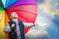 Happy boy portrait with bright rainbow umbrella