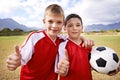 Happy boy, portrait and friends with thumbs up for soccer, winning or good match on outdoor field. Male person, children