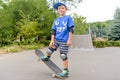 Happy boy practicing balancing on a skateboard Royalty Free Stock Photo